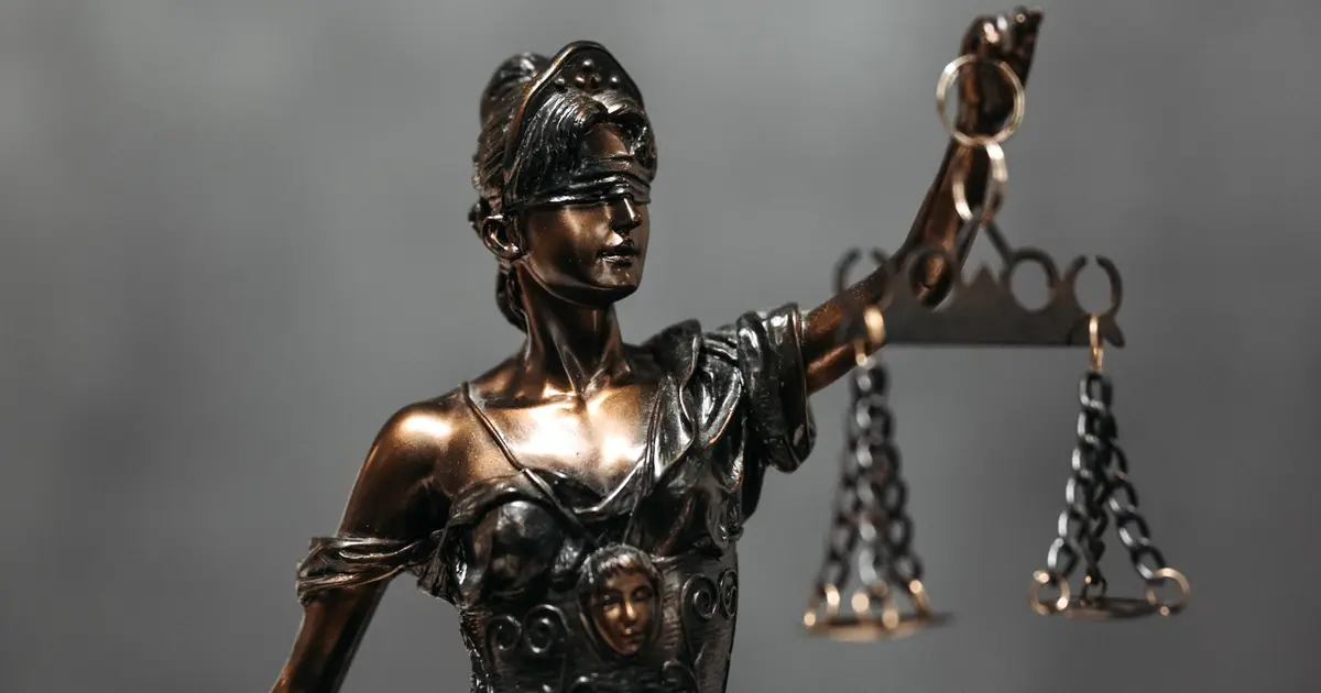 A figure of the lady of justice whose scales portray equality and the difference between revenge and justice
