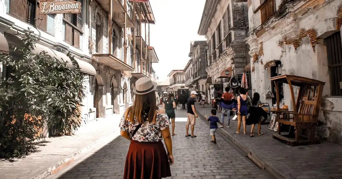 People walking in a historical village in the Philippines while being wary of Filipino taboos.