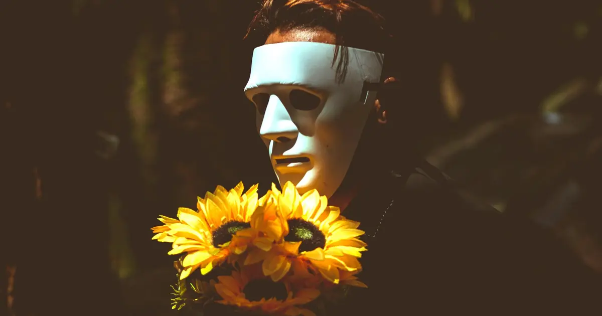 A man wearing a performer’s mask, reflecting one of the many first relationship mistakes