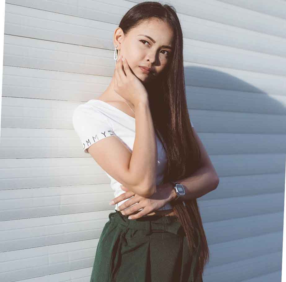 A Pinay girl with a white background behind her